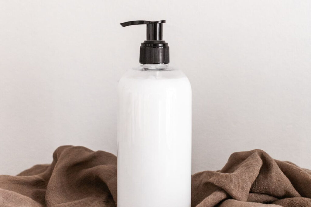 bottle of white leave-in conditioner for shiny hair