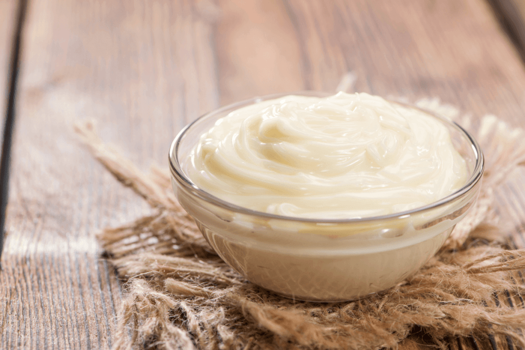 glass bowl of mayonnaise hair mask on piece of burlap