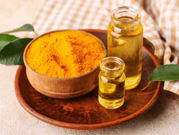 bowl of turmeric spice, and 2 bottles of turmeric oil