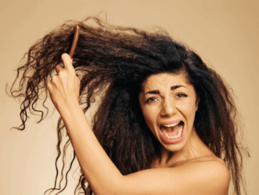 woman trying to get rid of frizzy hair