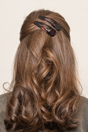 half up half down hairstyle with two barrettes