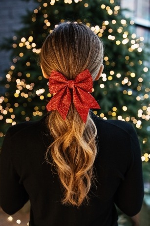 elegant low ponytail vacation hairstyle for long hair with bow