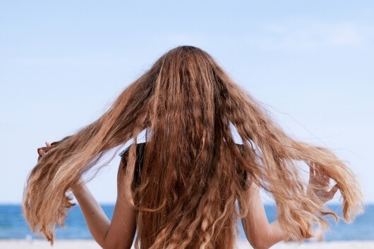 woman with long hair on the beach