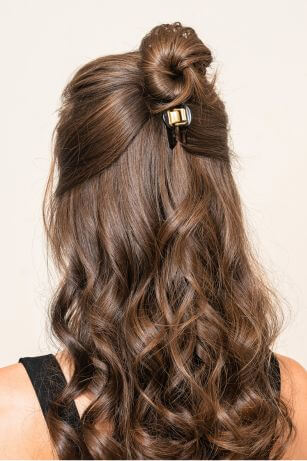 brown hair in half up hairstyle with bun