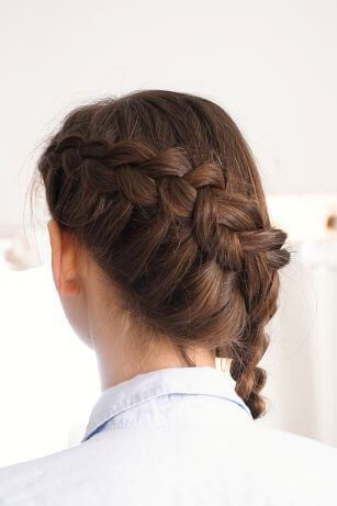 woman with brown hair with dutch braid across back of head