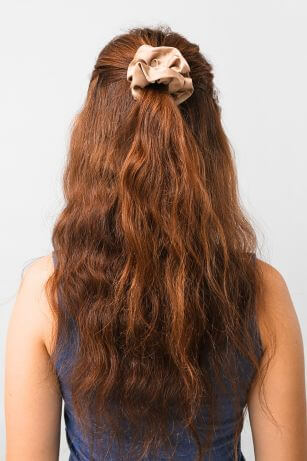 half up hairstyle with scrunchie